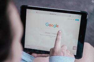 A picture of a person looking at their business search results on Google.
