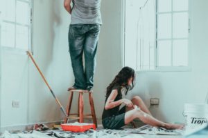 A picture of two people doing a DIY project in their house.