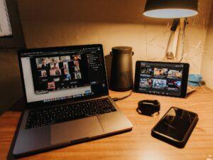 A picture of a laptop, tablet, and phone with social media content ready to post.