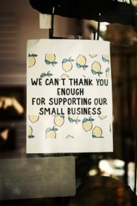 A sign thanks the customers of a small business