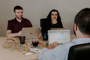 A picture of a group of co-workers looking at the improvement to their online reputation.