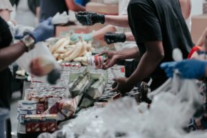 A picture of a company working together at a local food pantry.