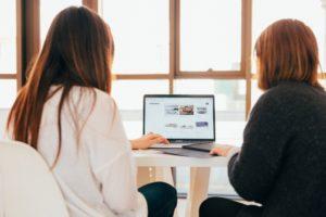 A picture of two women looking at and searching images on Google.