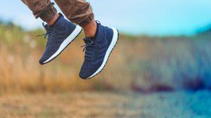 A picture of the feet of someone jumping off the ground, represents the boost positive content can give your reputation.