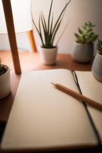A blank book and pencil waiting to be written in