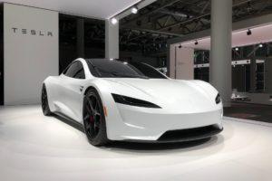  A picture of a Tesla car at a car show.