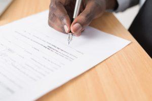 guy signing a legal doc